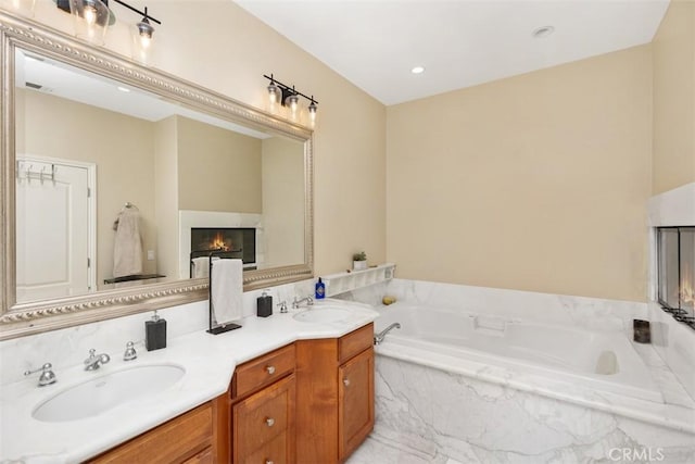 bathroom with a relaxing tiled tub and vanity