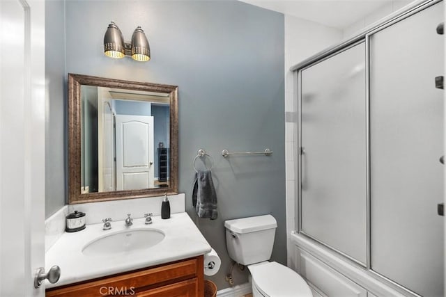 full bathroom with vanity, toilet, and shower / bath combination with glass door