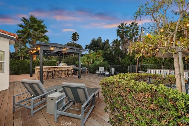 deck at dusk with an outdoor bar