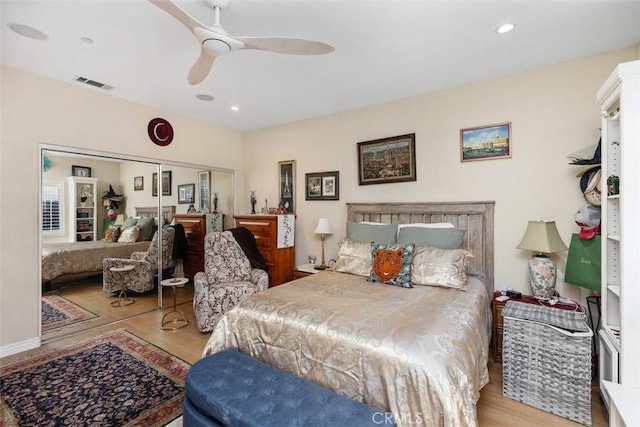 bedroom featuring a closet, light hardwood / wood-style flooring, and ceiling fan