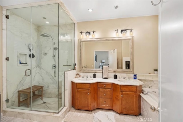 bathroom featuring separate shower and tub and vanity