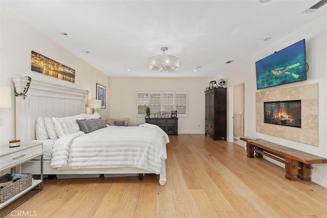 2308 S Ola Vis, San Clemente, CA 92672 - bedroom with visible vents, light wood-style floors, a glass covered fireplace, and baseboards