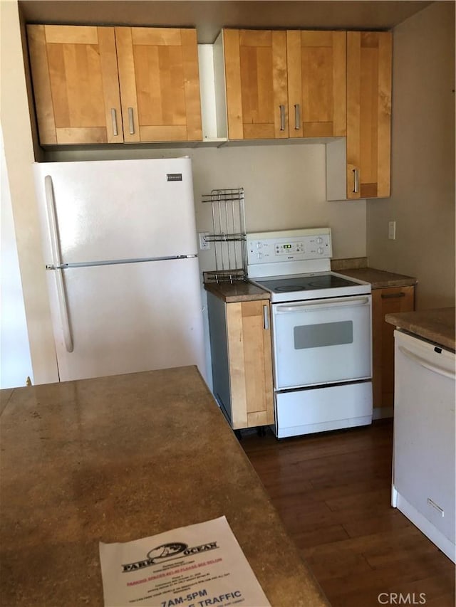 kitchen featuring white appliances and dark wood-type flooring