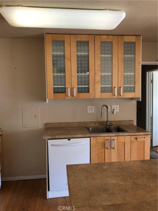 kitchen featuring sink, dishwasher, light brown cabinetry, and dark hardwood / wood-style floors