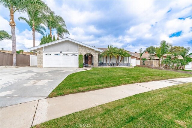 ranch-style home with a front lawn and a garage