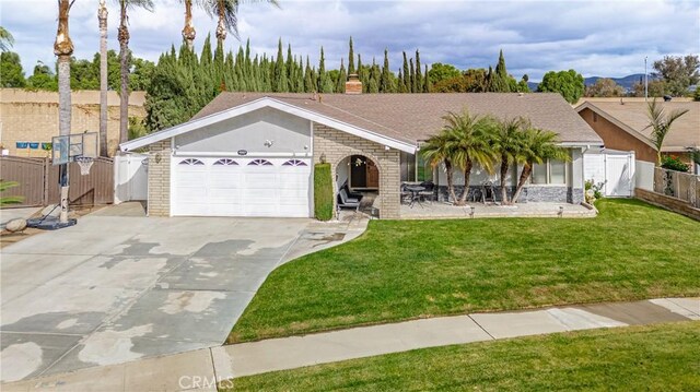 ranch-style house featuring a front yard and a garage