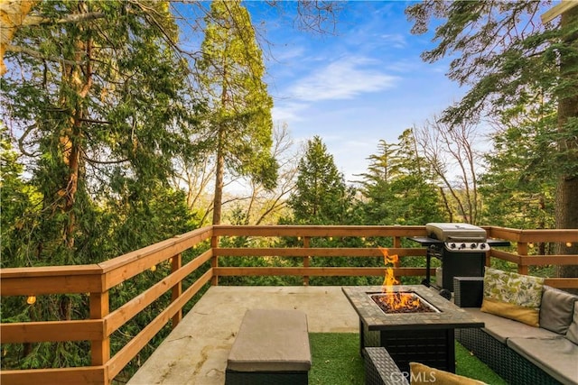 view of patio / terrace with a grill and an outdoor living space with a fire pit