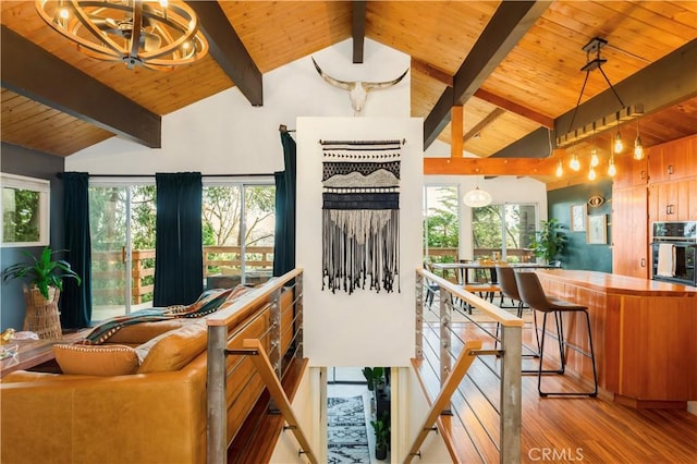 living room with high vaulted ceiling, wood-type flooring, beamed ceiling, and wooden ceiling