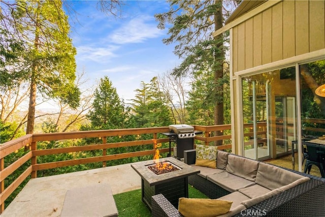 view of patio / terrace featuring a grill and an outdoor living space with a fire pit