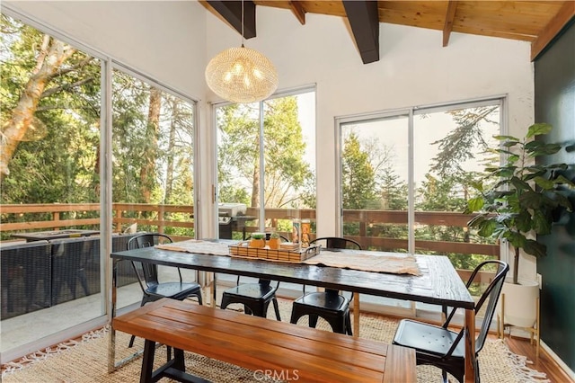 sunroom / solarium featuring vaulted ceiling with beams and wooden ceiling