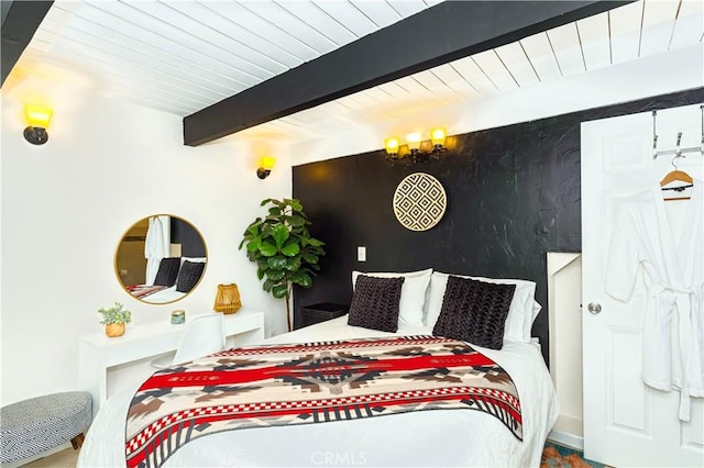 bedroom featuring wooden ceiling, a notable chandelier, and beamed ceiling