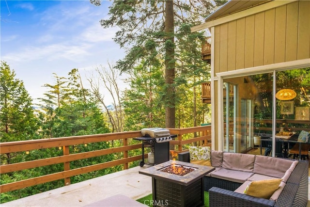 exterior space featuring grilling area and an outdoor living space with a fire pit