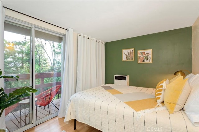 bedroom featuring access to exterior and wood-type flooring