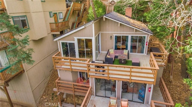 rear view of property featuring an outdoor living space and a patio