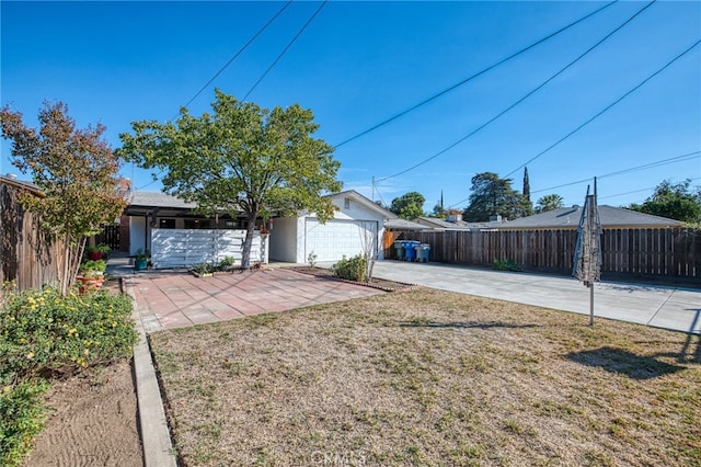 ranch-style home with a garage and a front lawn