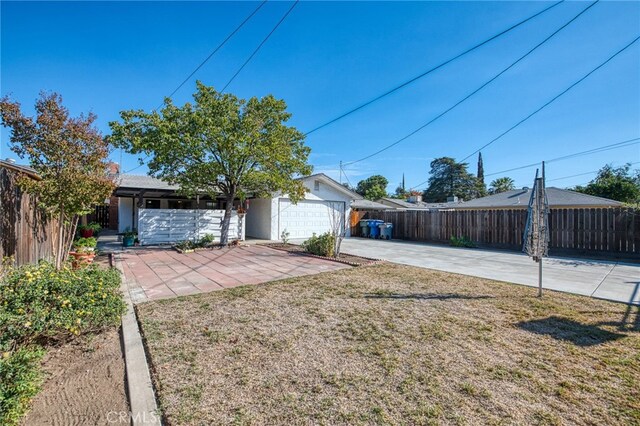 981 N Thorne Ave, Fresno, CA 93728 - view of yard featuring driveway and a garage