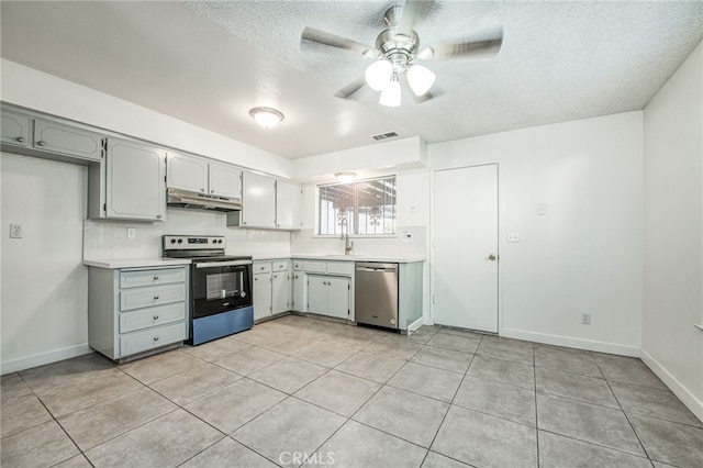 981 N Thorne Ave, Fresno, CA 93728 - kitchen with stainless steel appliances, under cabinet range hood, light countertops, ceiling fan, and a textured ceiling