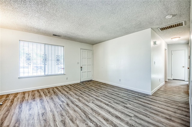 981 N Thorne Ave, Fresno, CA 93728 - spare room featuring wood finished floors and a textured ceiling