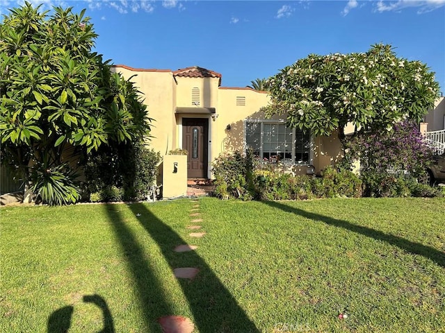 mediterranean / spanish-style house with a front yard