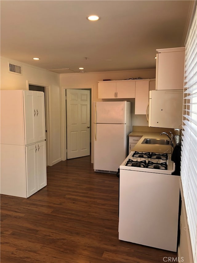 kitchen featuring white cabinets, dark hardwood / wood-style floors, white appliances, and sink