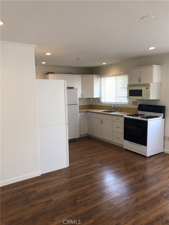 kitchen featuring white cabinetry, white appliances, sink, and dark wood-type flooring