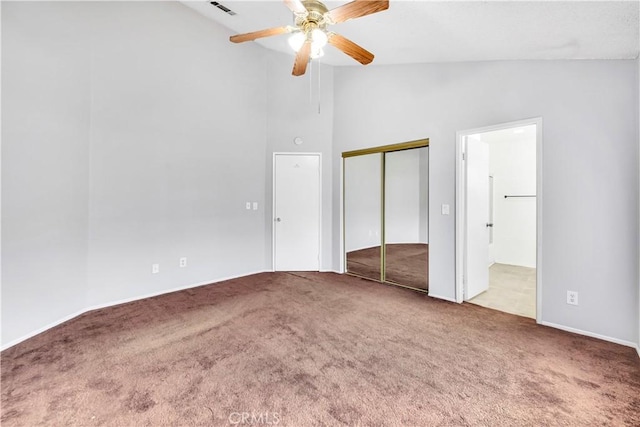 unfurnished bedroom featuring ceiling fan, light carpet, ensuite bathroom, and high vaulted ceiling