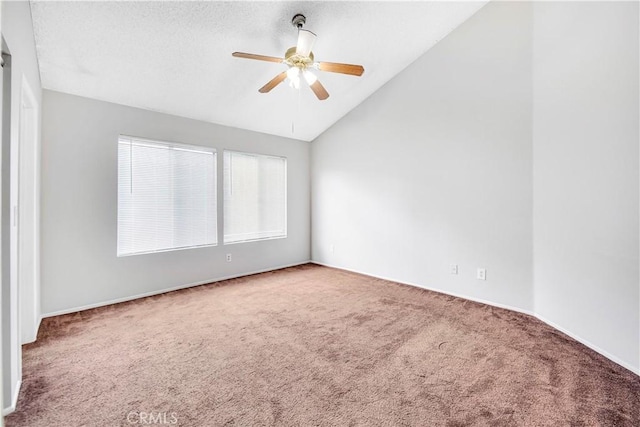 carpeted empty room with ceiling fan and vaulted ceiling