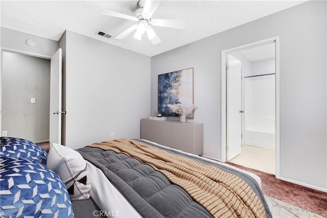 bedroom featuring ceiling fan, connected bathroom, a textured ceiling, and carpet flooring