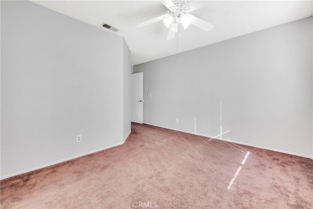 carpeted empty room featuring a textured ceiling and ceiling fan