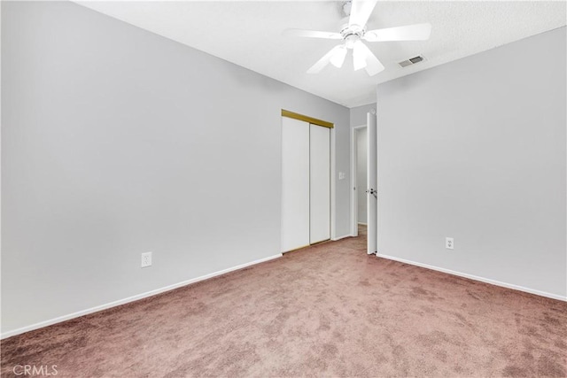 carpeted empty room with ceiling fan