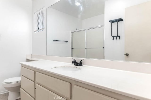 bathroom with walk in shower, vanity, tile patterned floors, and toilet