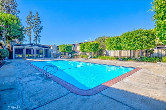 view of swimming pool featuring a patio area