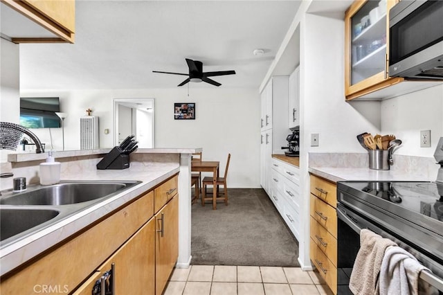 kitchen with ceiling fan, sink, light tile patterned flooring, and appliances with stainless steel finishes