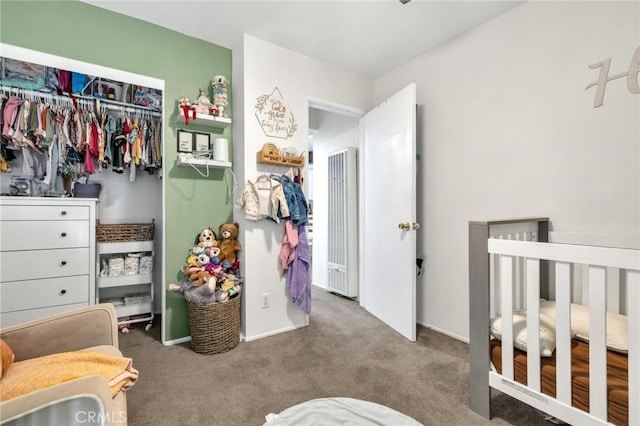 carpeted bedroom featuring a closet and a nursery area