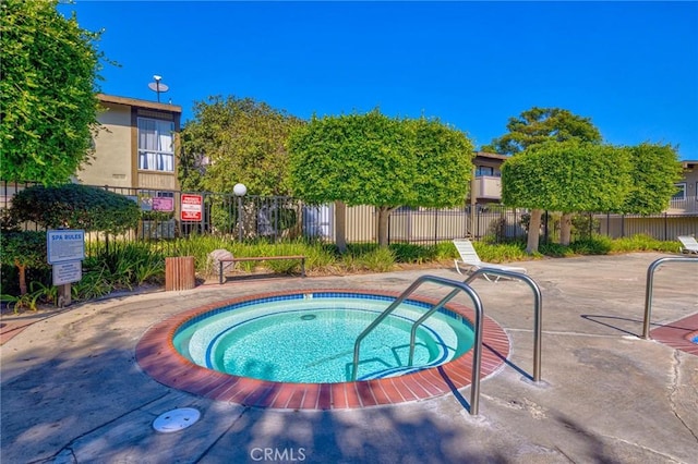 view of pool with a hot tub