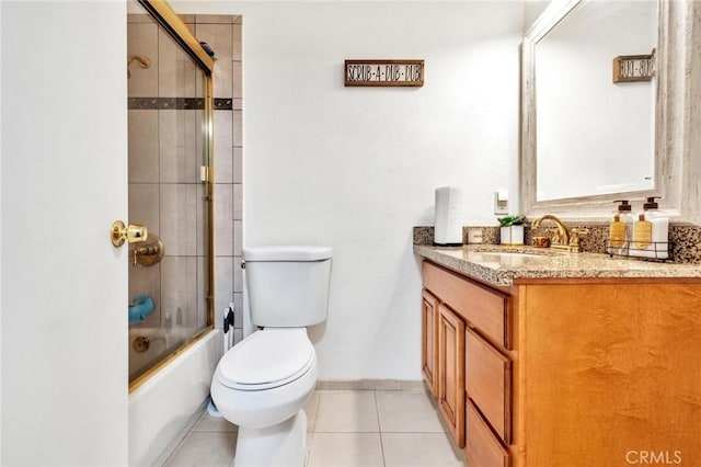 full bathroom featuring tile patterned flooring, vanity, bath / shower combo with glass door, and toilet