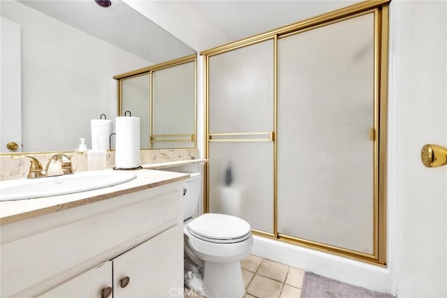 bathroom featuring tile patterned floors, vanity, an enclosed shower, and toilet