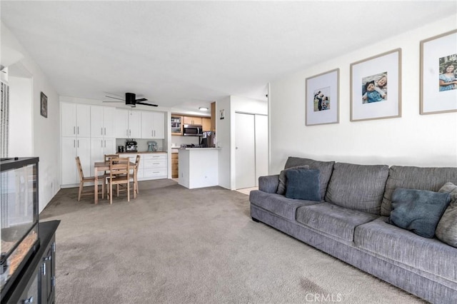 living room featuring light colored carpet and ceiling fan