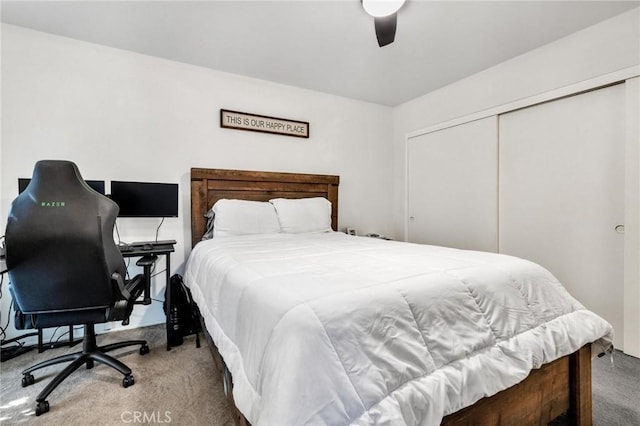 bedroom with ceiling fan, a closet, and light colored carpet