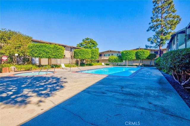 view of pool with a patio and a hot tub