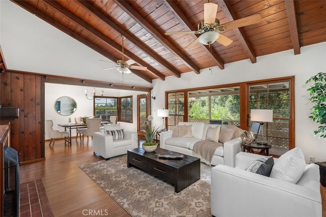 living room with ceiling fan with notable chandelier, hardwood / wood-style floors, vaulted ceiling with beams, and wood ceiling