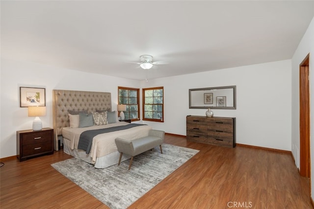 bedroom with hardwood / wood-style floors and ceiling fan