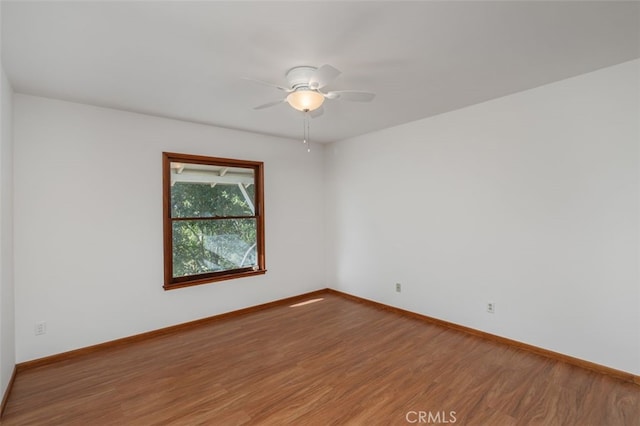 empty room featuring ceiling fan and hardwood / wood-style floors