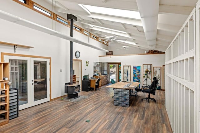 office space with dark hardwood / wood-style floors, high vaulted ceiling, beamed ceiling, a wood stove, and french doors