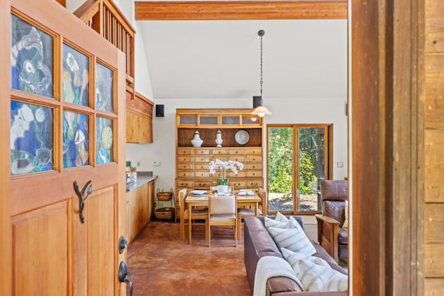 interior space with vaulted ceiling and concrete floors