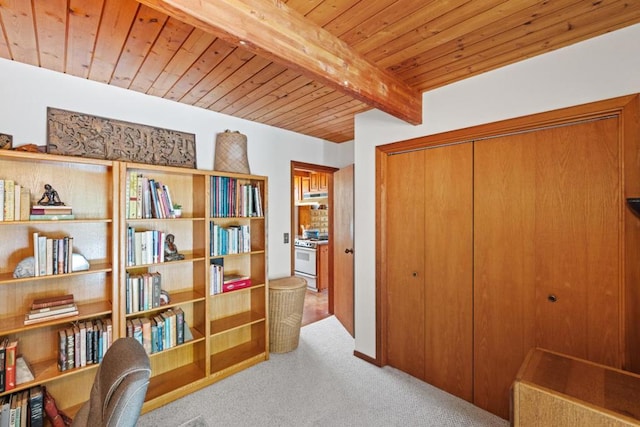 sitting room featuring wood ceiling, beam ceiling, and light colored carpet