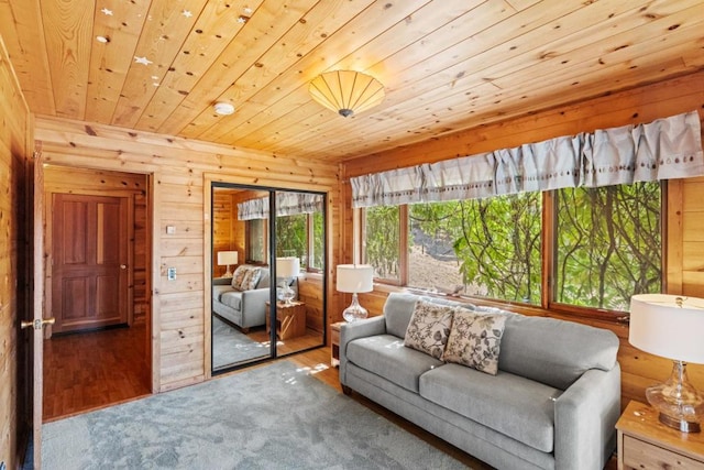 living room with wood ceiling and wooden walls