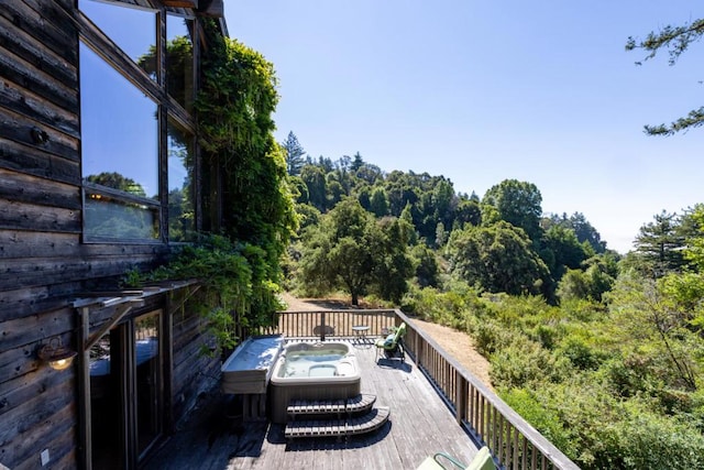 wooden balcony featuring a wooden deck and a hot tub