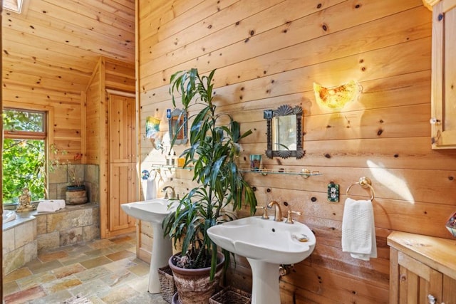 bathroom with sink and wooden walls