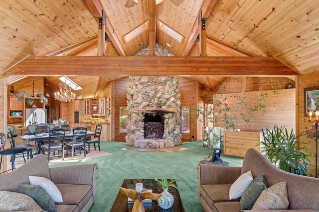 living room with wood ceiling, vaulted ceiling with skylight, carpet, a fireplace, and wood walls